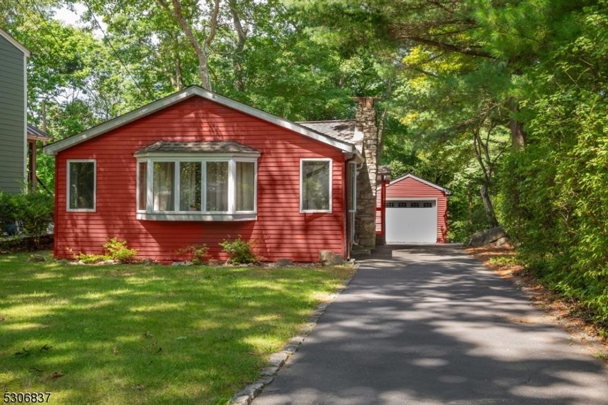 Expect to be impressed with care through out! Lake living situated on a pristine piece of  property surrounded by peace and tranquility.  Make this 3 bedroom lake style ranch your blank canvas to your dream home. Enter through the front door to be greeted by tons of natural sunlight in the living room with an open floor plan leading into the formal dining room. Two original stain glass windows accent the stone hearth wood burning fireplace leaving this formal dining room nothing short of perfection. The floor plans continues into the laundry room flowing directly into the bright and open kitchen featuring views into the back yard stone patio and level yard. A bonus third bedroom situated off the kitchen can also be used as a home office. A second out door entrance located off the kitchen leads you to the long expansive paved driveway and one car detached garage. Don't miss this opportunity to make this home yours!!!