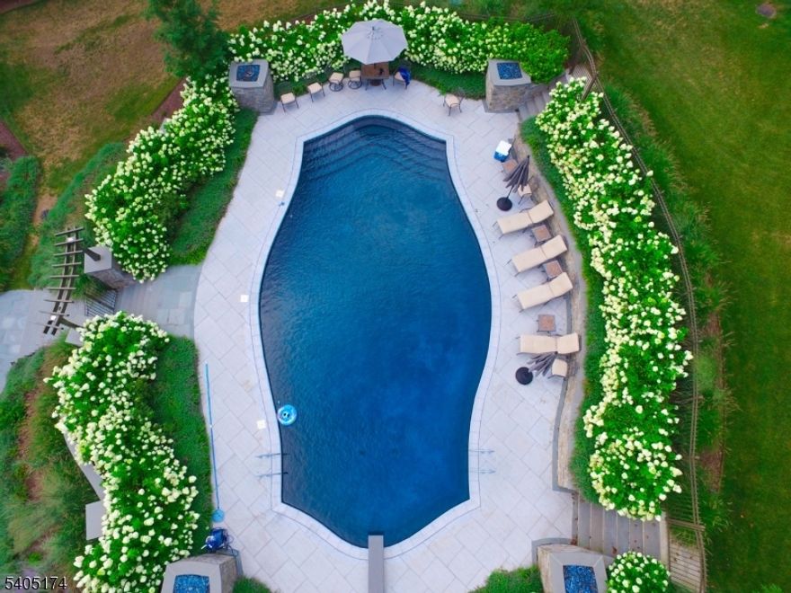 Vacation at Home in this private oasis with Guinite Heated In-Ground Pool, Tennis Court and top of the world homesite in the heart of Roxiticus Valley. Two story paneled library with built in bookcases,  palladium window and Grand Totally Custom Kitchen with state of the art stainless steel Viking appliances and chandeliers. Family room with vaulted ceiling, fireplace and French Doors to an oversized bluestone patio with built in grill and service area.This home is ideal for entertaining with the magnificent newer addition with Billiard Great Room, Wet Bar and spiral staircase to Wine Cellar. Master Bedroom with tray ceiling, fireplace and fabulous new Master Bath. Living room with 10' ceiling and fireplace. Finished basement, four fireplaces, elevator and much more!