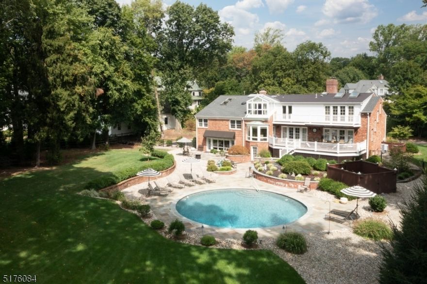 Private living in a prime Northside location on .84 acre's. This custom 5 bed, 4.2 bath home is bright, airy and has great flow. This home combines the open entertaining space with the versatility of separation and stand alone rooms for work, fitness and relaxation. With 3 levels that are above ground you have tremendous views out to the private backyard oasis that has a large mahogany deck, blue stone patio, pool and lush gardens and lawn. When entering the home you are greeted by the living room which has a see through gas fireplace that opens to the formal dining room. The designer kitchen with two islands, high end appliances and breakfast area opens to a family room. Upstairs there are 3 bedrooms, one of which is en suite and the other two share an updated hall bath. The floor above has a bedroom with ensuite, a yoga/meditation room or office and the master suite that has large walk-in closets, a shower and soaking tub that has a peaked glass ceiling, perfect for relaxing inside and looking up into a star filled sky. The expansive garden level features a walk-out family room with fireplace and summer kitchen including countertop sink, microwave and dishwasher that opens to the pool areas-this acts as a pool house. Large media/game room, home gym, craft room and laundry room, plus access from the oversized heated 2 car attached garage adds convenience.