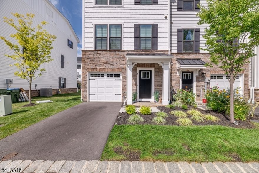 Built in 2024, loaded with premium upgrades, this stunning three-story end-unit townhome blends modern luxury, comfort, and convenience. From the moment you enter, you're welcomed by wide-plank wood flooring, neutral designer paint, soaring ceilings, recessed lighting, and custom window treatments that create a bright, sophisticated ambiance throughout. The 1st level offers a gracious foyer, convenient powder room, and a spacious open family room with sliding doors leading to a patio perfect for relaxing. Upstairs, the sun-filled main living level showcases an impressive custom kitchen designed to be the heart of the home. Crisp white cabinetry, a grand center island with built-in breakfast bar, and elegant pendant lighting make the space both stylish and functional. The kitchen flows seamlessly into the dining and living areas, creating an expansive open-concept layout ideal for gatherings. Large windows flood the home with natural light, while an elevated wooden deck extends your entertaining space outdoors. The 3rd floor features three generously sized bedrooms and two full baths. The luxurious primary suite includes a tray ceiling with recessed lighting, a spacious walk-in closet, and a private ensuite bath with dual vanity. A well-appointed hall bath with tub and shower serves the additional bedrooms. Immaculate and move-in ready, this exceptional home is just moments from the center of Hackettstown, with its charming shops, restaurants, and NJ Transit service to NYC.