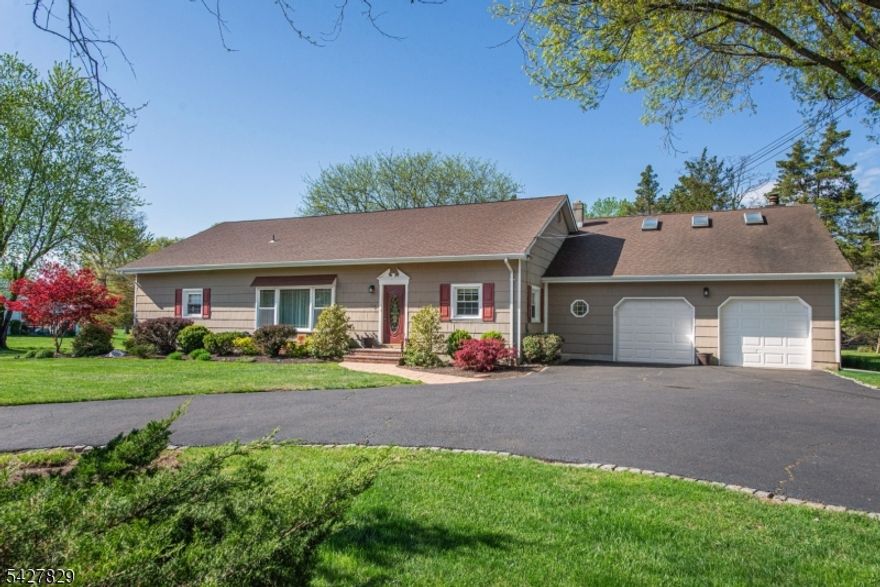 TURN-KEY 4 bedroom expanded ranch in the desirable Belle Mead section of Hillsborough on 1 acre of parklike grounds. Large foyer flanked by living & dining rooms w/ gleaming hardwood floors, crown moldings & plenty of natural light. The kitchen is nicely updated with custom maple cabinets, granite countertops & island with seating making entertaining a breeze, along with separate breakfast area. The family room with wood burning fireplace also has sliding glass doors out to the fully screened porch w/ceiling fan for outside dining.  Primary suite offers full bath with walk in closet, along with 2 more bedrooms all featuring hardwood floors.  Recently updated main bath has double vanity & custom tub closure. Laundry and inside entrance from the two car garage complete this level. Upstairs is one additional bedroom with skylights & minisplit AC or can be used as flex space for home office or exercise. On your visit, be prepared to admire the large patio, tranquil outdoor space and mature landscaping & take in the beauty this property offers. This home is convenient to schools, town, shops & businesses. Welcome home!