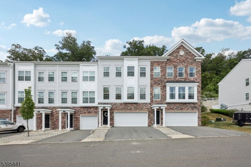 Welcome home to this beautifully maintained 3-bedroom, 3.5-bath Townhome nestled on a peaceful wooded cul-de-sac in The Hills community. Step into the ground floor where you'll find a versatile home office or den, an inviting retreat ideal for working from home or hosting guests. Full bathroom and direct garage access add convenience to this level. Upstairs, discover the open-concept main living area designed for modern living. The spacious living room is filled with natural light from large windows, creating a welcoming atmosphere perfect for conversation and relaxation. The living area transitions seamlessly into the elegant dining room, ideal for both intimate dinners and lively gatherings. The home chef will love the well-appointed kitchen featuring custom cabinetry, granite countertops, a stylish tile backsplash, stainless steel appliances, and a center island with bar seating perfect for casual meals or entertaining. Step through the rear door to a private patio, perfect for grilling and al fresco dining. A powder room completes this level. Upstairs, the tranquil primary suite offers a spacious walk in closet and private en suite bath. Two additional bedrooms, full bathroom and laundry room complete the upper level. Additional highlights include a two-car attached garage, ample driveway parking, and low HOA fees. Enjoy The Hills lifestyle with tree-lined sidewalks, a community playground, and easy access to shopping, dining, major highways, and NYC transportation.