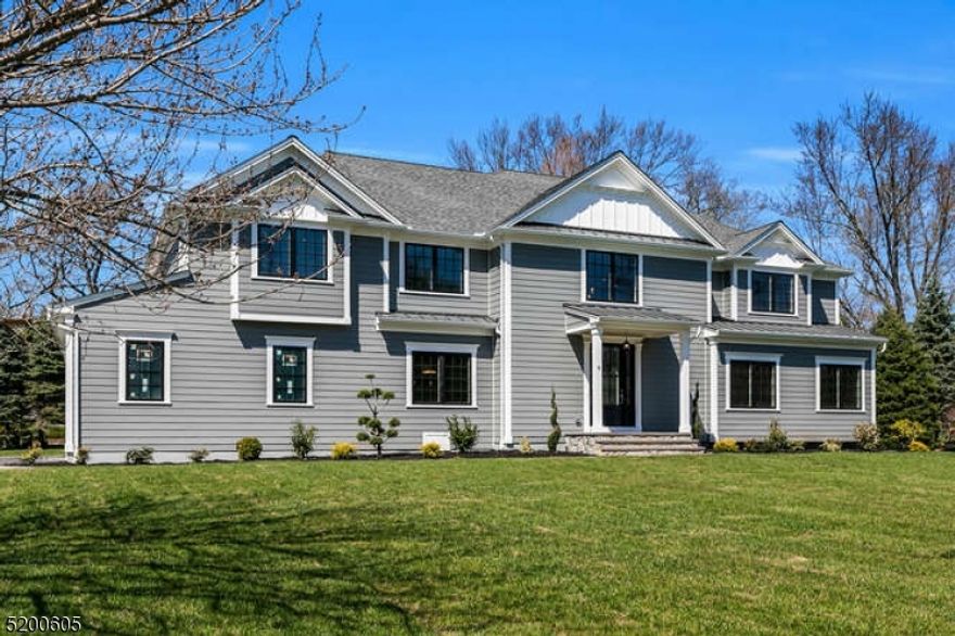 Magnificent fully renovated custom colonial situated on 1.06 acres! Meticulous attention to detail throughout, including 4" red oak flooring and custom moldings and millwork. Oversized windows fill the home with natural light. Grand two-story foyer leads to formal living room. Formal dining room with coffered ceiling and access to kitchen through the butler's pantry with wine refrigerator. Stunning kitchen with quartz countertops, GE Monogram stainless-steel appliances and custom white cabinetry extending to the ceiling. Additional highlights include the farmhouse sink, an enormous island with prep sink, seating, and storage, and breakfast area with double doors to rear patio. Adjacent family room with gas fireplace, coffered ceiling and double doors to yard. Completing the first floor are mud room, bedroom, and half bath. Primary bedroom boasts a double tray ceiling with crown molding, two custom fitted closets and private covered balcony. Luxurious primary bath has soaking tub and spa shower. 3 additional bedrooms and an en-suite and Jack and Jill bath both with quartz countertops and porcelain tile floors. An expansive bonus room with vaulted ceiling works well as an office space or media room. Finished lower level with rec room, bedroom and full bath. Outside features paver patio with built-in fire pit and expansive yard. Located in top NJ school district close to shopping, parks, restaurants, and transportation, this spectacular home will exceed your every expectation!