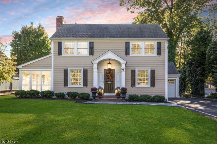 This classic Colonial has been beautifully renovated to blend timeless elegance with today's luxury. Step inside to a thoughtfully designed open-concept layout that centers around an inviting kitchen and family room. The chef's kitchen, boasting a grand island with seating for six, top-of-the-line Thermador stainless steel appliances, and elegant finishes, flows seamlessly into a large family room with a Heatilator fireplace and integrated surround sound system. Double sliding doors from the kitchen lead to an expansive patio with a built-in firepit, creating a stunning outdoor living area. A butler's pantry with sink and kegerator connects to the formal dining room, ensuring effortless hosting. The living room, featuring a wood-burning fireplace, opens to a light-filled sunroom, offering a serene retreat for quiet moments. An attached 1-car garage that leads directly to a generous mudroom, designed with ample storage for all your needs. Upstairs, you'll find four spacious bedrooms, each with custom closet organizers. The primary suite is a luxurious retreat, complete with a beautiful RH chandelier, dual closets, and an ensuite bathroom with a double vanity. A large laundry room is conveniently located upstairs, making daily routines a breeze. The high-ceilinged walk out basement adds even more value to this home. A versatile layout featuring an office/workout room, and an expansive rec room/game room, and additional storage and utility space complete the lower level.