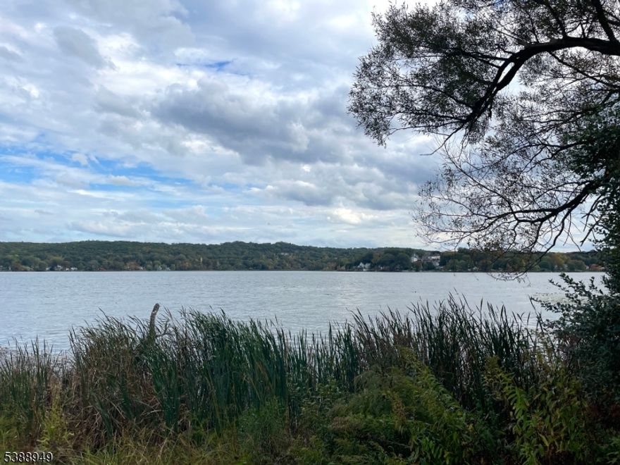 Investor Special with a Rare Lake Musconetcong Opportunity -  Breathtaking views of Lake Musconetcong set the stage for this unique property! Nestled on a hillside with a circular driveway and three car garage, this fixer-upper comes with an additional separate flat lot across the street... creating endless potential for expansion, new construction, or investment possibilities. The existing home is being sold AS IS and is in need of a full renovation, offering the perfect blank canvas for those with vision. Whether you're a builder looking for your next project, an investor ready to capitalize on lakefront demand, or a creative homeowner eager to design your dream retreat, this property delivers rare value and location. Amazing lake views from both lots. Cash or renovation loans only. Endless potential in a highly desirable lake community with public water/sewer - Conveniently located near shops, dining, and major roadways while still offering that serene lakeside escape. Don't miss this chance to reimagine lake life on Lake Musconetcong! One hour from Midtown!