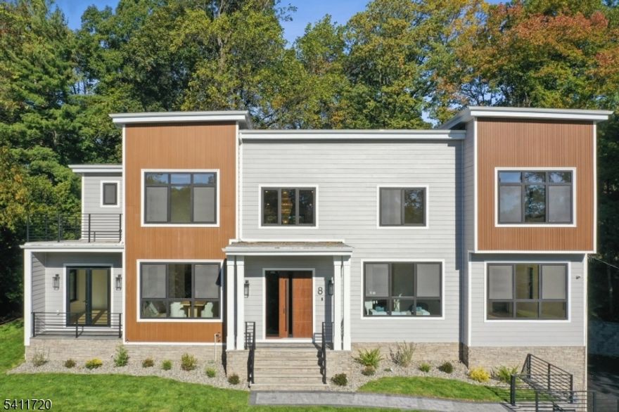 From the moment you arrive, this residence feels intentional. Set on over half an acre in one of the town's most desirable locations, the home unfolds with quiet confidence and nearly 6,000 square feet of thoughtfully designed living space. Inside, light moves effortlessly through an open floor plan designed for both daily living and elevated entertaining. Formal and informal spaces flow together without interruption, creating a natural rhythm from the living room to the dining room and into the heart of the home. The kitchen anchors it all, finished with custom cabinetry, quartz surfaces and professional-grade stainless steel appliances, centered around a generous island where mornings begin and evenings gather. The first floor offers space for all: a private and convenient bedroom suite, a bonus room and a dedicated office in which to work from home without compromise. Upstairs, the second level is both expansive and intimate. Four oversized bedrooms offer comfort and proportion, including a serene primary suite designed as a true retreat. One bedroom enjoys its own en-suite bath, while two others share a bath. The fully finished lower level extends the experience with soaring nine-foot ceilings and versatile space for recreation, media, fitness or guests, complete with a full bath. This is a home built with scale and presence, designed to live beautifully at every level.