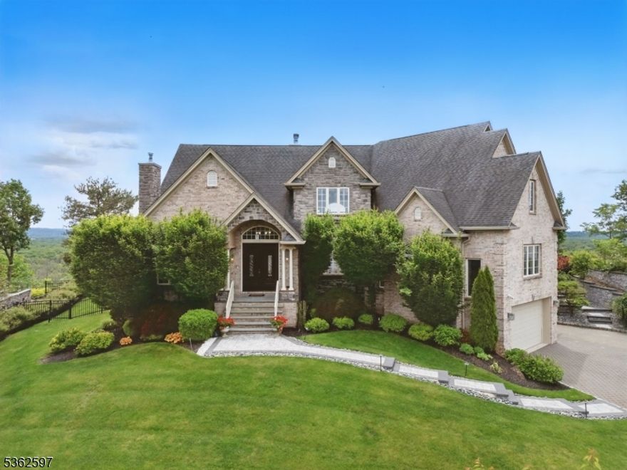 Welcome to a one-of-a-kind 5 bed 4.5 bath Colonial masterpiece in the prestigious Rock Ridge Estates. Crafted with impeccable precision in 2009, this residence is a striking blend of timeless elegance and modern sophistication, offering panoramic views of the serene Great Piece Meadows. Step inside to Brazilian hardwood floors, a custom Castelo granite island, & elegant window treatments. The chef's kitchen is a culinary dream, featuring premium appliances including a Wolf gas range, double ovens, and an oversized Sub-Zero refrigerator, all seamlessly integrated into custom cabinetry & luxurious finishes. The home boasts dual primary suites, one on each level each complete with his & her walk-in closets & spa-inspired baths with jetted tubs & oversized stall showers. Upstairs, enjoy breathtaking views from the private terraces of the secondary bedrooms. New hot water heater & furnace installed in 2024. Additional features include a heated 3-car finished garage, heated driveway, & an advanced security system with cameras. The professionally landscaped grounds are enhanced with full exterior lighting & irrigation system. Outdoor living is equally exceptional, with a custom chef's kitchen equipped with premium stainless steel appliances, an integrated grill station, & stone-clad countertops. A stately pergola, elegant stone firepit, & built-in seating complete the expansive patio. This residence is more than a home it is a legacy - designed to endure, impress, & welcome.