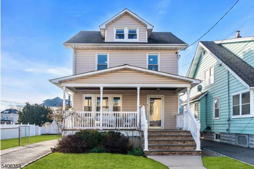 Set on a desirable extra-wide lot, this classic Colonial home offers space, character, and modern comfort in a convenient location, just steps from schools and retail. The welcoming foyer reveals the home's hardwood floors and original oak trim, adding warmth and timeless charm. The thoughtfully updated kitchen offers granite countertops, stainless steel appliances, a pantry closet, a powder room, and a built-in breakfast bar with additional cabinet storage. The formal dining room, filled with abundant natural light, connects the kitchen to the living room, creating an inviting flow throughout the main level. The second level features three bedrooms, a full bath, and access to a beautifully finished walk-up attic that provides a versatile space ideal for a home office, creative studio, or rec room. A modern natural gas steam boiler and four zones of ductless air conditioning and heating provide efficient, year-round comfort. Outdoor living shines with a large front porch and backyard deck, a gravel firepit area framed by paver-lined planting beds, and a spacious, fully fenced lawn offering plenty of room to relax, play, or garden. A detached one-car garage adds everyday convenience. The full basement is well suited for storage, a workshop, or hobbies, and features a French drain and sump pump system for added peace of mind. A wonderful opportunity to enjoy classic architecture, modern updates, and exceptional outdoor space in one of Roselle Park's nicest neighborhoods.