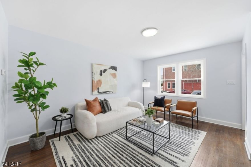 Welcome to this charming and beautifully updated home that's located on a quiet block of Irvington, NJ. This 2 bedroom home features HW floors throughout, a fully updated kitchen that includes SS appliances, quartz countertop, as well as a fully renovated bathroom with plenty of other upgrades throughout.  This property also features a finished basement for additional living space. You will also enjoy the outdoor space with its patio and enclosed backyard, making it perfect for entertaining and relaxing.  This property is conveniently located minutes away from schools, shopping centers, restaurants as well as trains and buses to NYC. Come and see this home. You will be glad you did!!  Please note, property comes with 1 parking spot in the rear. There is also private permitted parking for you in the front. There is no HOA and no HOA monthly fees. L.A. is owner of property. ***MULTIPLE OFFERS RECIEVED. H & B DUE BY TUESDAY  2/24/26 AT 6PM.***