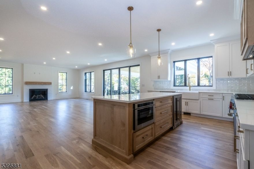 Experience timeless elegance and modern sophistication in this brand-new custom masterpiece crafted by Little Bear Builders. Every inch of this home showcases meticulous design, flawless craftsmanship, & the finest quality finishes. Step through the grand entrance into a breathtaking two-story foyer, where soaring ceilings and architectural details make an unforgettable first impression. This extraordinary residence includes seven spacious bedroom suites, each with its own luxurious en-suite bath, complemented by a total of eight impeccably designed bathrooms. The chef's kitchen is a culinary work of art, featuring Sub-Zero and Wolf appliances, bespoke cabinets & refined selections curated for both beauty and functionality. The primary suite is a private retreat, offering two expansive walk-in closets, oversized windows, and high ceilings that flood the space with natural he spa-inspired primary bath offers a freestanding soaking tub, custom double vanity, and a large walk-in shower a retreat designed for ultimate relaxation. Oversized  windows throughout bathe the home in light, beautifully showcasing the wide-plank white oak floors & timeless finishes. The lower level redefines entertainment with a custom wet bar, full-size refrigerator, microwave, and extensive built-in cabinetry. Outdoors, the lifestyle continues with an expansive covered patio, professionally landscaped grounds, underground sprinklers, and a full-home generator, ensuring peace of mind in every season.