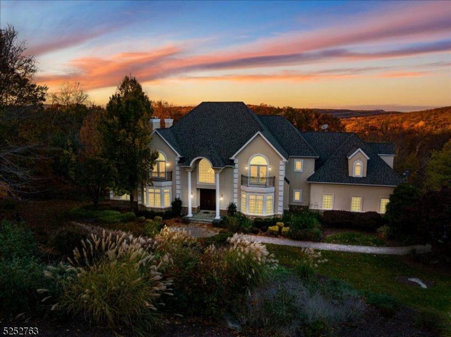 Privately situated on just over 3 acres in the prestigious Valhalla Ridge neighborhood, this stunning, impeccably maintained property boasts an expansive, flowing floor plan with sophisticated design & elegant finishes throughout. The main level offers a dramatic 2-story foyer with a curved staircase, a gourmet kitchen with a large center island, top-of-the-line appliances, a breakfast area, and butler's pantry, formal living & dining rooms, a family room with custom built-ins, an office, library, powder room, and laundry room. The second level offers a luxurious primary suite with two walk-in closets, a sitting area & a gorgeous bath with double sinks, a stall shower & jetted tub, as well as three generous bedrooms with ensuite baths. The beautifully finished basement offers bonus recreation & entertaining space with an impressive media room, game room with bar, wine cellar, gym, and full bath. Additional features include four fireplaces, gleaming hardwood floors on the main level, high ceilings, custom trims & moldings, abundant natural light, plentiful storage throughout, and a 3-car attached garage. Step outside to relax in the peaceful backyard oasis that includes a lovely deck overlooking the pristine in-ground swimming pool in a surround of lush, mature landscape.