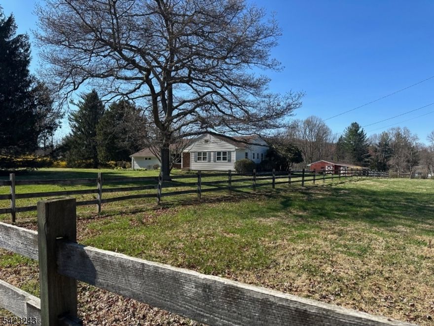 In the heart of Tewksbury's storied horse country, this sunlit five-acre retreat invites you to slow down, breathe deeply, and live the life you've imagined. Open, level fields stretch beneath wide skies, where mornings begin with the quiet rhythm of hooves and evenings fade into golden light across four fenced pastures.Designed with the equestrian lifestyle in mind, the property offers a four-stall barn with hay storage and a Morton pole barn ready for your equipment, trailers, and everything that supports life with horses. Whether you're riding out at dawn or returning home at dusk, this is a place where every day feels connected to the land.Offered for the first time in over half a century, the lovingly cared-for three-bedroom, two-bath ranch home tells its own story. Built in 1960, it welcomes you with warm oak hardwood floors, a stone raised-hearth fireplace perfect for gathering on cool evenings, and simple, timeless spaces that feel instantly like home. A slate-floored mudroom stands ready for muddy boots and busy days, while the full basement and attached two-car garage add ease and practicality.From your doorstep, access Tewksbury's scenic trail system or explore the nearby paths of Christie Hoffman Park, where miles of riding await. Despite its peaceful setting, the property remains close to top-rated schools, charming local shops, and convenient routes to New York City.It's a place to build memories, to ride, to gather, and to live in rhythm with the land.