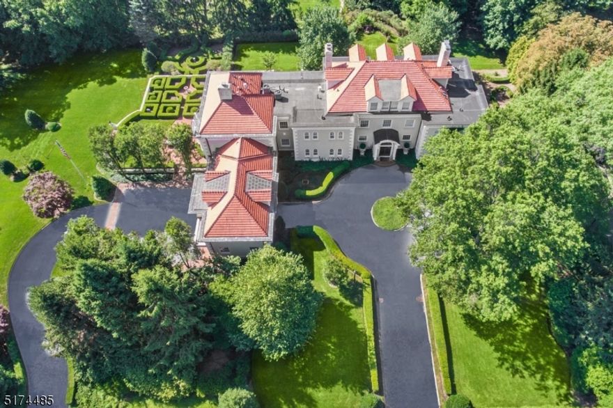 Once in a lifetime opportunity to own the most magnificent home in Short Hills! This home is absolute perfection, with great natural light as it is south facing, on almost 2 acres! Plenty of room for a pool & tennis court! This classic English Manor has been meticulously expanded & restored to the highest specifications of David Rosen AIA. It has the perfect floor plan for entertaining on a grand scale or having a quiet night at home! You'll love the stunning new gourmet kitchen designed by Matthew Quinn that is totally open to the family room w/ fireplace. Both rooms have easy access to expansive brick patios & property. There is a separate butler's kitchen, formal music room, stunning wood-paneled dining room w/ fireplace, conservatory, home office w/built-ins, & wood paneled library w/ fireplace on first level. On the 2nd level there is a luxurious primary suite w/ fireplace,  dressing room, two huge walk-in closets & two primary baths, 3 additional bedrooms & 3 more baths, massive home office with golf simulator & huge  state of the art exercise room. There is a third level w/ 3 more bedrooms & full bath. Beautifully finished lower level has recreation room, wet bar, walk-in temperature controlled wine cellar, billiards room, playroom & ample storage. Easy 1st floor access to attached garages with Tesla charger. Improvements include: 2 new generators 2022, new furnace & New AC 2020, new EV charger 2019 & enough property for Pool & Tennis Court.