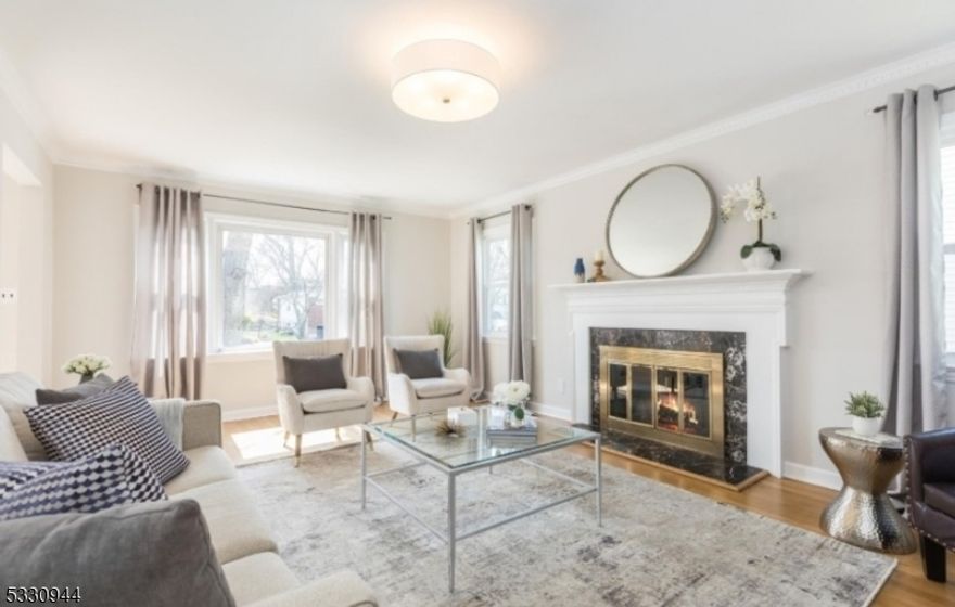 Elegant, Light-Filled Ranch in a Premier Location. Set on a quiet, tree-lined street in a highly desirable neighborhood, this beautifully maintained 3-bedroom residence offers an exceptional blend of comfort, style, and convenience. Ideally situated just 0.5 miles from top-rated Wyoming Elementary, 0.8 miles to NYC trains, and minutes from Millburn, Maplewood, and vibrant downtown shopping and dining. A gracious, sunlit interior welcomes you with seamless flow between living spaces. The inviting living room opens to a spacious eat-in kitchen, thoughtfully appointed with stainless steel appliances, custom cabinetry, and abundant storage, perfect for both everyday living and entertaining. A charming den/sunroom offers a serene retreat with views of the private, fully fenced backyard. The primary bedroom features generous double closets and access to a well-appointed hall bath, while two additional bedrooms share a convenient Jack-and-Jill bathroom. The walkout lower level provides versatile living space, ideal for a recreation room or home office, along with a powder room, laundry area, and direct access to an oversized two-car garage. Additional highlights include central air conditioning and radiant heated bathroom floors. Offering timeless appeal, functional living, and an unbeatable location, this home presents a rare opportunity not to be missed.