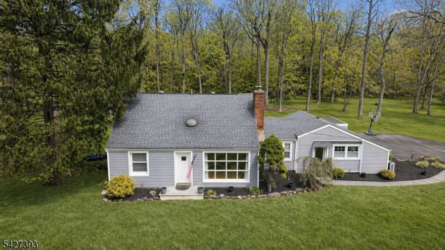 Unsurpassed setting! Set on over 2 private, park-like acres in desirable Martinsville, this beautifully maintained home offers the perfect blend of space, updates, and natural surroundings. The property features an expansive lawn, mature trees, and a picturesque trout stream, creating a peaceful, retreat-like setting. Inside, the updated kitchen is the heart of the home, showcasing rich wood cabinetry, granite countertops, center island seating, and newer appliances. The kitchen opens beautifully to the dining area and inviting living room with hardwood floors and a brick fireplace with inset wood-burning stove. The spacious family room provides additional living space for relaxing or entertaining. The flexible layout offers 2 bedrooms and 2 renovated full baths on the first floor, plus 2 additional spacious bedrooms upstairs. Step outside to an oversized custom deck ideal for entertaining complete with a hot tub and scenic views. Additional highlights include newer heating and cooling systems, newer electric, full basement with laundry and storage, and a 1-car garage. Enjoy the charm of Martinsville living with a convenient location near shopping, dining, parks, schools, and major commuter routes.