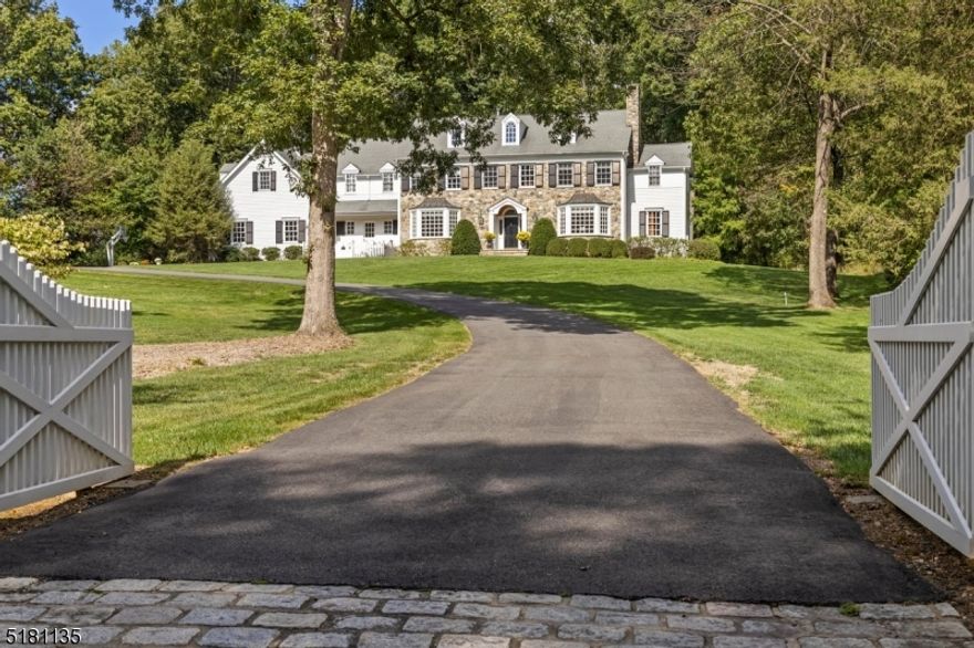 This pristine Custom Bucks County Colonial is perched on a picturesque 2 acre wooded lot.  The river stone facade, authentic true divided light windows, wood louvered wrought iron hinged shutters, and beautifully lit cupola highlight some of the custom details of this unique property.  Enter through the front driveway gates to the beautiful front entry or to the English garden with a stepping stone walkway and white picket fence to the service entry with Dutch door.  Wide plank pine wood floors and an abundance of natural light add to the home's warmth and ambiance.  The step-down family room boasts a large stone, wood burning fireplace with barn beam mantle and glass panel French doors to the large bluestone patio with knee wall.  A French door opens to the library with custom woodwork and built-ins.  Large living room has a wood burning fireplace, glass panel French doors and opens to the wet bar and powder room.  The kitchen has beaded inset cabinets, spacious granite island and large dining area, as well as French doors leading to the blue stone patio.  Adjacent to the kitchen is a butler's pantry, which opens to a formal dining room.  Two staircases provide access to the second floor, which features a large primary suite, 4 additional bedrooms; 2 full baths; a laundry room and an oversized bonus room. Additional features include walk-up attic, a 3.5 car garage, full basement, and brick walkways. Basking Ridge School system. (Far Hills mailing address)