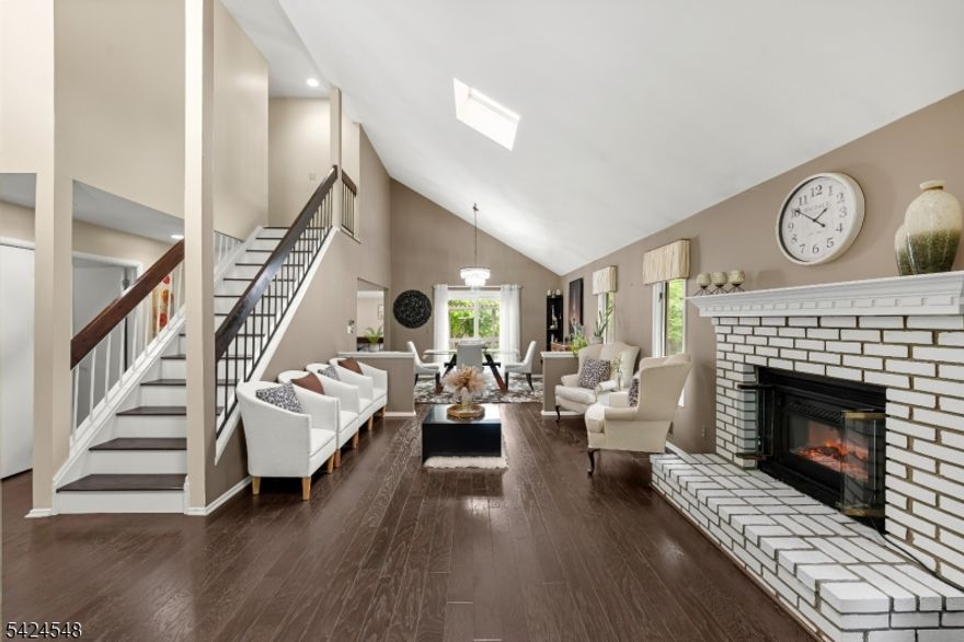 Beautifully updated East-facing energy efficient 4-BD 2.5 BA home offering modern upgrades, and exceptional indoor-outdoor living. This move-in ready property features has it all: solar panels (paid, 2017), Nest thermostat, HVAC with tankless water heater (2025), New 2-patio doors (2025), LG-washer (2019) & dryer (2015), 4 zone auto irrigation system, vaulted ceilings, engineered HWD floors, crown moldings, R-15 attic insulation and fresh interior paint. Impressive man's cave bsmnt and outdoor patio for your entertainment needs. The main level includes a welcoming entry with living-dining, powder room, and convenient laundry access to the 2-car garage with automatic opener and EV charger. The open-concept layout flows into a cozy family room with dining area and electric fireplace.  The fully renovated kitchen showcases beautiful cabinetry, granite countertops, center island, modern backsplash, pendant lighting, under-cabinet lighting, and newer appliances including a 2025 Ref, 2022 stove,  with built-in disposal system. Upstairs offers 4 BD, each with built-in closets, accent walls, recessed lighting, and large windows. The primary suite features a skylight, wall sconces, and an updated master bath (2022) with stall shower. The bsmnt includes a built-in bar, projector, and entertainment system perfect for a home theater or recreation space.   Exterior highlights include a private wooded backyard, landscaped grounds, deck, pergola, and sun-covered outdoor seating area.