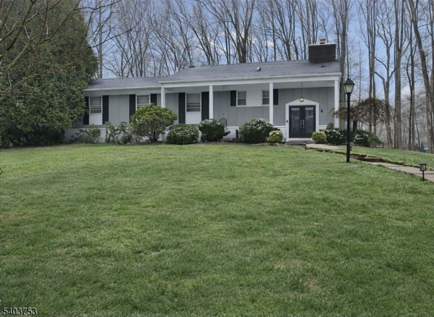 LOCATION!! LOCATION!!  Perfectly nestled on just under an acre in a coveted double cul-de-sac neighborhood, this beautifully maintained CUSTOM raised ranch combines thoughtful design with seamless indoor-outdoor living. A welcoming foyer opens to a sun filled living room featuring vaulted ceilings and a classic wood burning fireplace, creating a warm gathering space. The adjoining newly added sunroom overlooks the wooded backyard and provides access to a spacious deck for all year round living. The main floor centers around a well equipped kitchen with double ovens, a cozy breakfast area and an adjacent formal dining room. The primary suite features a renovated full bathroom and generous closet space. Three additional bedrooms share a full hall bath, and a convenient powder room completes the level. The walkout lower level offers exceptional versatility, featuring a family room and a recreation room with its own wood burning fireplace. This level also includes an additional bedroom with a laundry area, a convenient powder room and direct access to the patio and two car attached garage. With excellent curb appeal, flexible living spaces, and a serene setting, this home presents a wonderful opportunity for comfortable everyday living and entertaining alike.