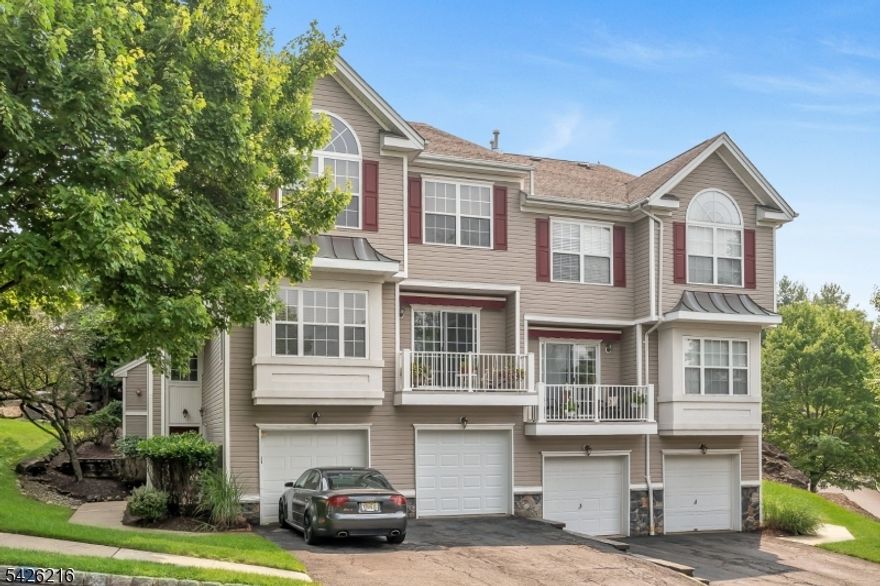 Beautifully maintained 2-bedroom, 2.5-bath end-unit townhouse in the highly desirable Summit Falls community offering three levels of spacious living. A dramatic two-story foyer welcomes you into the entry level featuring a versatile family room/den, ideal for home office, gym, or additional living space, with direct access to the attached garage.The main living level offers an open-concept layout with bright living room, gas fireplace, formal dining area, powder room, and an eat-in kitchen with pantry. Door off dinning room to Private patio, perfect for relaxing or entertaining.The upper level features two generously sized bedrooms, each with access to full updated bath, including a primary suite with vaulted ceilings, walk-in closet, and updated en-suite bath. Convenient upper-level laundry adds everyday ease.Additional highlights include hardwood floors, central air, natural gas heat, and excellent storage. New Roofs, Decks, Patios and Railings throughout the community.  Residents enjoy scenic waterfall views, gazebo, and community pool. Conveniently located near shopping, dining, major highways, and NYC transportation.