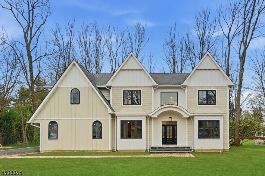 Welcome to this luxurious new-construction 6-BR, 6.5-bath Center Hall Colonial set on a level 0.38-acre lot in one of Florham Park's most sought-after neighborhoods. A custom luxury-grade statement front door introduces the exceptional craftsmanship throughout. The grand 2-story foyer is flanked by formal living and dining rooms.The sun-filled double-height family room with floor-to-ceiling windows is anchored by a gas fireplace and flows seamlessly into the chef's kitchen featuring premium panel-ready appliances, a large quartz center island, quartz backsplash, walk-in pantry, bar area, and breakfast area. Arch glass doors open to a paved patio and expansive backyard, ideal for indoor-outdoor living. The main level includes a private en-suite bedroom with walk-in closet, ideal for guests, a powder room with Carrara marble vanity, dedicated home office, mudroom, and direct access to the two-car garage. The second level offers 4 en-suite bedrooms, including a luxurious primary suite with dual walk-in closets and spa-inspired bath, plus a convenient laundry room. The fully finished lower level adds a recreation room, media lounge, bedroom, and full bath.Enhanced by custom millwork, designer lighting, refined architectural details, and exceptional curb appeal, this home is ideally located near shopping, dining, commuter routes, library, recreation facilities, and top-rated schools. Low taxes and a 10-Year Builder Warranty complete this offering.