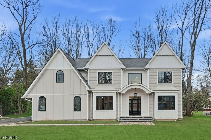 Welcome to this luxurious new-construction 6-BR, 6.5-bath Center Hall Colonial set on a level 0.38-acre lot in one of Florham Park's most sought-after neighborhoods. A custom luxury-grade statement front door introduces the exceptional craftsmanship throughout. The grand 2-story foyer is flanked by formal living and dining rooms.The sun-filled double-height family room with floor-to-ceiling windows is anchored by a gas fireplace and flows seamlessly into the chef's kitchen featuring premium panel-ready appliances, a large quartz center island, quartz backsplash, walk-in pantry, bar area, and breakfast area. Arch glass doors open to a paved patio and expansive backyard, ideal for indoor-outdoor living. The main level includes a private en-suite bedroom with walk-in closet, ideal for guests, a powder room with Carrara marble vanity, dedicated home office, mudroom, and direct access to the two-car garage. The second level offers 4 en-suite bedrooms, including a luxurious primary suite with dual walk-in closets and spa-inspired bath, plus a convenient laundry room. The fully finished lower level adds a recreation room, media lounge, bedroom, and full bath.Enhanced by custom millwork, designer lighting, refined architectural details, and exceptional curb appeal, this home is ideally located near shopping, dining, commuter routes, library, recreation facilities, and top-rated schools. Low taxes and a 10-Year Builder Warranty complete this offering.