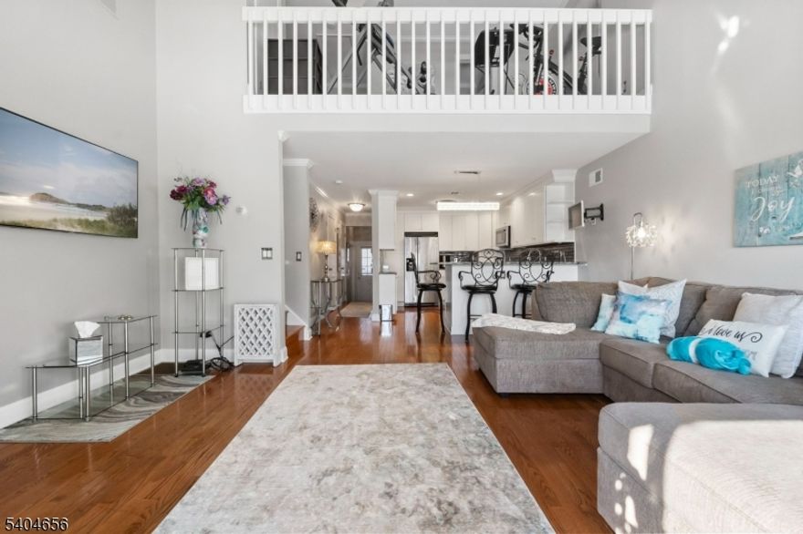 This One is a Wow! Welcome to this beautifully updated home in a fabulous neighborhood. Enter to gleaming hardwood floors that set the tone for many tasteful updates, and an open concept living space with plenty of natural light. Get ready to fall in love with a stunning kitchen updated in 2021. Enjoy granite countertops with a spacious breakfast bar, stainless appliances and thoughtfully chosen quality finishes. Relax and unwind in a comfortable living/dining room area with high ceilings and woodburning fireplace as the focal point of the room. A convenient deck off the living area provides a cozy outdoor retreat to unwind and relax while overlooking beautiful, mature trees. An updated powder room is located on the first floor as well. Upstairs, a spacious primary bedroom gleams with newer hardwood flooring and abundant closet space. The main bath and additional loft area complete this floor - perhaps office space or guest area. As a bonus, the attic, with pull downstairs, provides additional storage with shelving. Step downstairs to a partially finished walkout basement with two large versatile rooms.  So much potential and usable space for a den, workout room or storage. Laundry and utility room complete the lower level. Enjoy the convenience of public water and sewer, natural gas, numerous community amenities including pool, clubhouse, and tennis courts and convenience to abundant shopping in this well-established community.