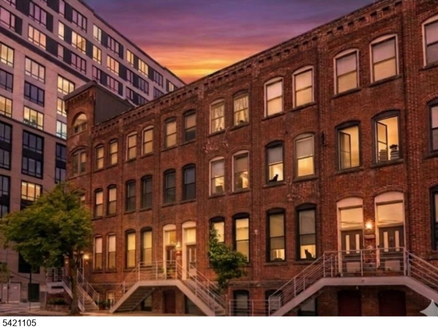 Offer instructions and brochure posted to MLS documents section, due Tues 4/21 by noon. Located just two blocks from Newark Penn Station, this distinctive one-bedroom plus cloffice space, 1.5-bath bi-level residence offers private street-level entry from your own front porch, a covered parking space, and access to an interior courtyard.  An exceptional combination of convenience and calm in the heart of the Ironbound. Welcome to The One, set within the historic Chocolate Factory, a beautifully preserved 1888 building. Inside, the thoughtfully designed layout separates living from retreat. The sunlit upper level features cathedral ceilings, oversized east-facing windows, a powder room, gas range, and dishwasher. Downstairs, the lower level offers a quiet bedroom, full bath, and flexible office/"cloffice  space. Original interior brickwork and a century-old timber column add warmth, texture, and character, creating a space that feels both industrial and refined. Natural light fills the home throughout the day, while the lower level offers a more tucked-away, restful feel. Beyond the residence, the courtyard provides a rare outdoor escape, framed by mature trees, bamboo, and sun-warmed brick. Just outside, Ferry Street restaurants, bakeries, and cafes bring the energy of the Ironbound to your doorstep. With in-unit laundry and immediate access to transit, this home blends practicality, character, and style in one of Newarks most vibrant neighborhoods.