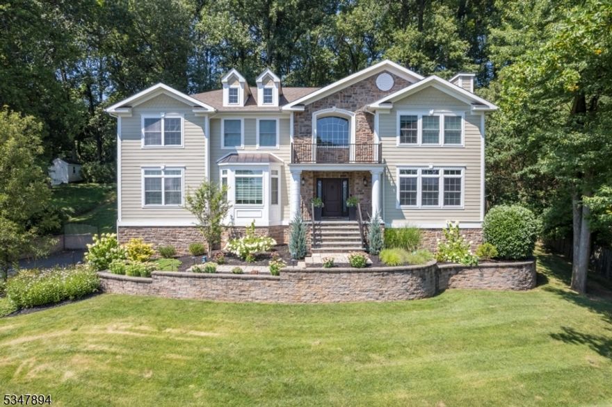 EXQUISITELY UPDATED HILLTOP COLONIAL ON OVER HALF ACRE IN COVETED CHATHAM TWP! As you approach this stunning home, you'll note the professional landscaping, new stone walkways, but the unbelievable eastern view from the majestic front entry sets the tone for what's awaiting inside. Grand 2-story Entry Foyer welcomes w/ circular staircase, inlaid hardwood floors & beautiful millwork. Formal Living & Dining Rooms continue the elegant touches complemented by oversized windows w/ transoms, a gas fireplace, high-end light fixtures & more. Expansive Eat-In Kitchen w/ custom cabinetry, granite countertops, SS appliances (Viking, Sub Zero, Bosch, Dacor), 2 sinks, center island, pantry wall & beverage bar w/ wine fridge. Glass sliding doors lead to back Patio with lined trees for privacy. Ensuite Bedroom and Home Office completes the First Level. Upstairs, the Primary Suite is a relaxing retreat full of natural light w/ an impressive Walk-in Closet/Dressing Room & ensuite bath with double vanity, clawfoot soaker tub & oversized walk-in shower. 3 spacious Bedrooms w/ great closet space, 2 Full Baths & Laundry Room meet all needs for convenience & comfort. Amazing Lower Level has soaring ceilings, Playroom & incredible Rec Room/Home Theater w/ projector, audio, pool table & access to 3-car garage. Smart Home features, generator & more upgrades. Short drive to Berkeley Heights train station, w/ direct lines to NYC,  access to shopping & restaurants in BH & New Providence.