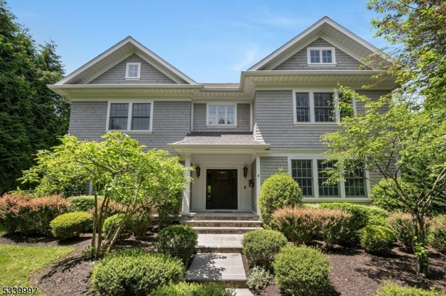 Experience luxury and functionality in this stunning, newer construction home in Summit's top-rated Lincoln-Hubbard school district. A private drive leads to this impressive shingle and stone Colonial designed by David Rosen. A grand foyer opens to the gourmet kitchen with spacious island, luxury appliances, and custom cabinetry. A breakfast area flows seamlessly into a sunlit family room with coffered ceiling, wainscotting, and gas fireplace. Step outside onto the deck, perfect for entertaining or enjoying peaceful lofty views. The first floor also features a gracious dining room with wainscotting and an octagonal beamed ceiling, an elegant living room with a gas fireplace, a private study with custom shelving and wainscotting and built-in speakers throughout the first floor and deck. Upstairs, find four large bedrooms, the laundry room and three baths, including a hall bath, en-suite, and luxurious spa-like primary bath with shower, jetted tub and dual sinks. The primary bedroom is generously sized and has a spacious walk-in closet. The lower level, finished with Italian tile floors, offers high ceilings, a full bath, a generous rec room, ample storage, and a second laundry area. Outside, extensive landscaping and hardscaping was completed by the current owners. An oversized three-car garage completes this fine home. Set in a sought-after location with top-tier schools, this home combines timeless elegance, modern amenities and privacy, an opportunity not to be missed!