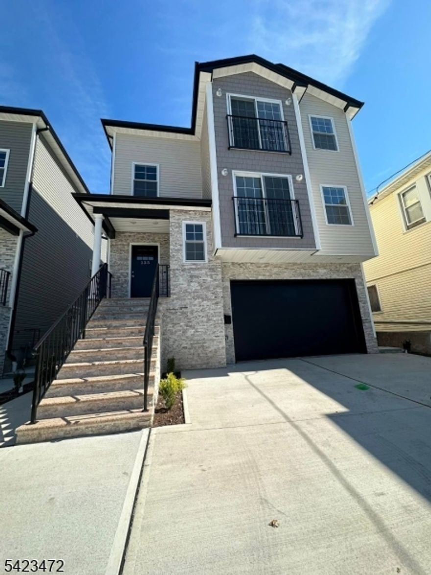 Welcome to this newly constructed (2024) first-floor, open-concept apartment. This sun-filled unit offers three spacious bedrooms and two full bathrooms, featuring hardwood flooring throughout. The unit includes central air and forced hot air, along with a modern kitchen equipped with granite countertops, stainless steel appliances, and ample cabinet space. The primary bedroom features a walk-in closet and a private en-suite bathroom. In-unit laundry is provided for tenant convenience. Conveniently located near major highways and NJ Transit, this property offers an easy commute to New York City. Close proximity to shopping, dining, and Newark Liberty International Airport. One off-street parking space included. Pictures were taken prior to the tenant moving in.