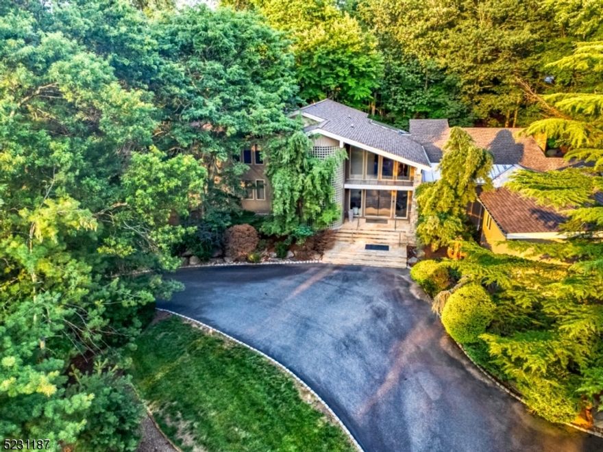 Welcome to this beautiful and expansive home located in Livingston's premiere neighborhood of Chestnut Hill. With a rarely seen modern architectural style welcoming you as you enter with soaring ceilings and clean lines, this 7,700 sq foot home has 5 bedrooms, including a massive private primary suite, and 9 bathrooms total. This striking home is nestled on .86 acres and set back, with lush landscaping bringing a peaceful sense of privacy, plus a soft-water filtered pool tucked in the back. Complete with a pool cabana indoor space with shower and powder room, as well as a home theatre room, a chef's kitchen, and fully finished basement - this property's style is very unique, while keeping an extremely sensible layout and a welcoming ambience.
