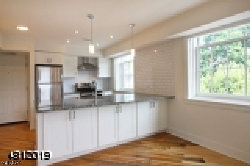 The warmth of historic details meets Manhattan loft-like finishes in a gracious renovation.  A large open room allows you to create your lifestyle with flexible living space in this third floor Lambertville, loft-style apartment. In the kitchen, granite counters with deep-set sink and stainless-steel appliances. Above, subway tile back-splash on two walls and exposed painted brick. Loft bedroom space above has two closets and full bath. Wood floors on first level and laminate in the bedroom.  Off-street parking. Fabulous location, amidst activities for evening, shopping and outdoor fun.