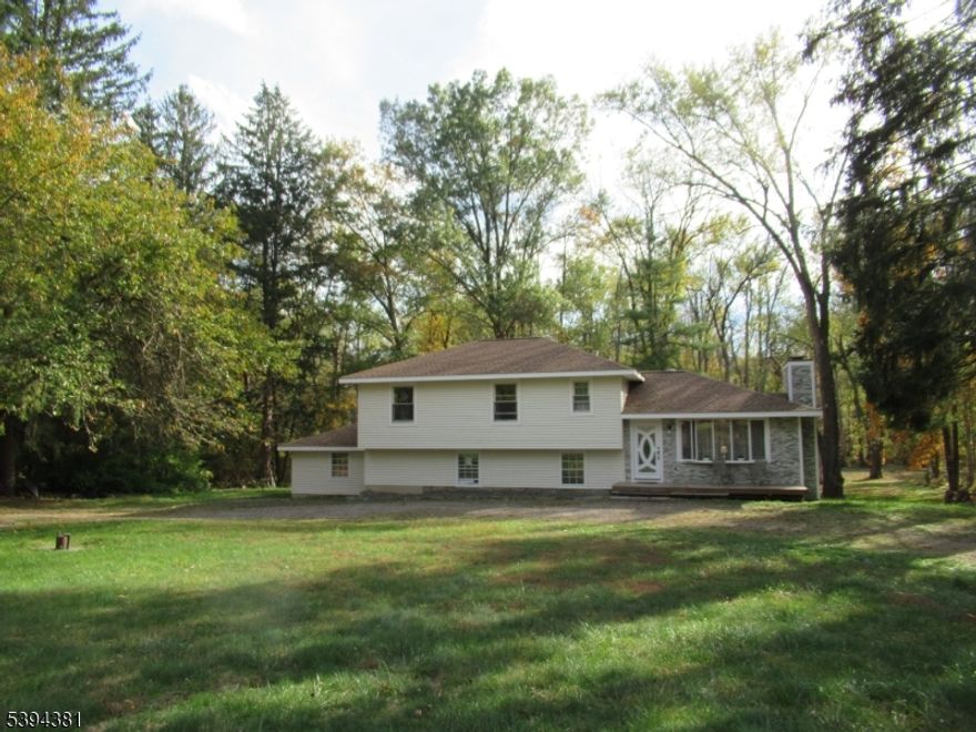 Amazing fully renovated single-family home set on nearly 2 acres of picturesque land in desirable Washington Township. Privately located on a quiet road bordering the Musconetcong River, this property combines natural beauty with modern comfort. The home features a new roof, siding, stone veneer front, deck, new doors and windows, upgraded chimney. Inside, enjoy new insulation, engineered wood flooring, fresh paint, recessed lighting, and a spacious renovated recreation room perfect for entertaining or relaxation. Recent updates include brand-new plumbing, electrical, and water systems, plus an added bathroom and two large walk-in closets. Home has 3 attics. Whether as a peaceful weekend getaway or a full-time residence surrounded by nature, this home offers modern finishes, thoughtful design, and timeless appeal.