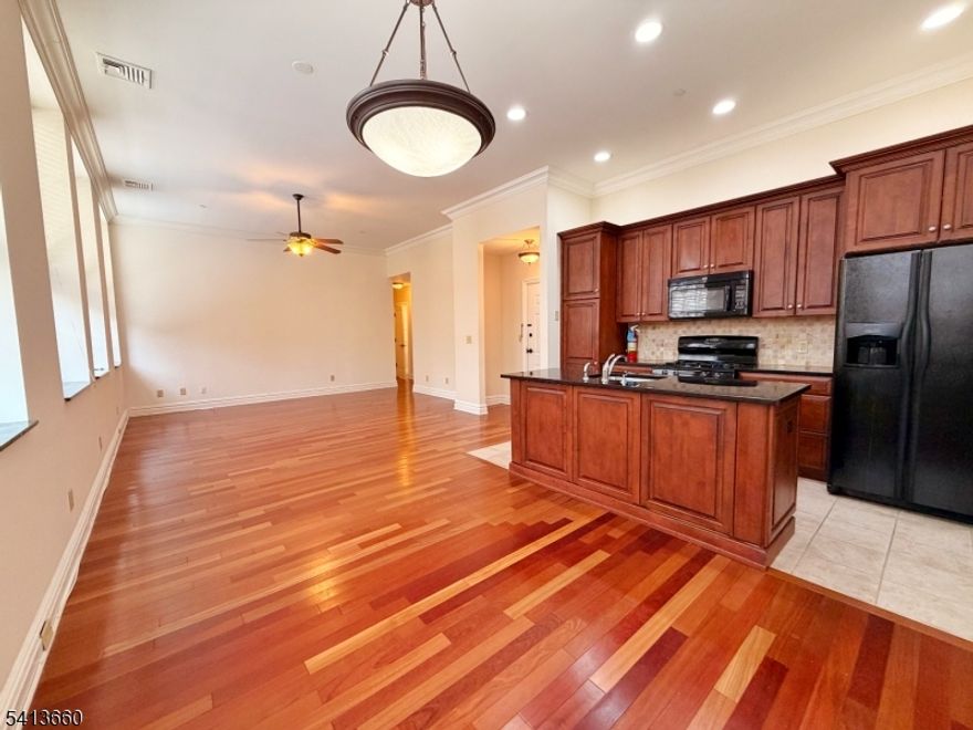 Welcome to The Residences at Forest Mill, where space, finish quality, and convenience come together in a way most rentals simply do not.This expansive nearly 1,400 square foot 2-bedroom, 2-bath residence lives more like a home than an apartment. Twelve-foot ceilings, wide plank hardwood floors, and oversized windows create a bright, open feel the moment you walk in. The designer kitchen anchors the space with granite countertops, clean modern lines, and room to actually cook and entertain, not just reheat.The layout works. Bedrooms are properly separated. Storage is included. In-unit washer and dryer keep daily life simple. Keyless entry adds security and ease. Off-street parking removes a daily headache. The elevator building is quiet, well maintained, and built for residents who value comfort over chaos.Location is a major advantage. You are a short walk to the Hawthorne Commuter Rail, five minutes to the Glen Rock Main Line station, and just minutes from Ridgewood dining, shopping, and everyday essentials. You get true commuter access without sacrificing a calm residential setting.This is an ideal option for someone downsizing from a home, relocating, or simply upgrading their lifestyle without the maintenance. Large, high-quality rentals like this are rare and move quickly.Schedule a private tour before it's gone.