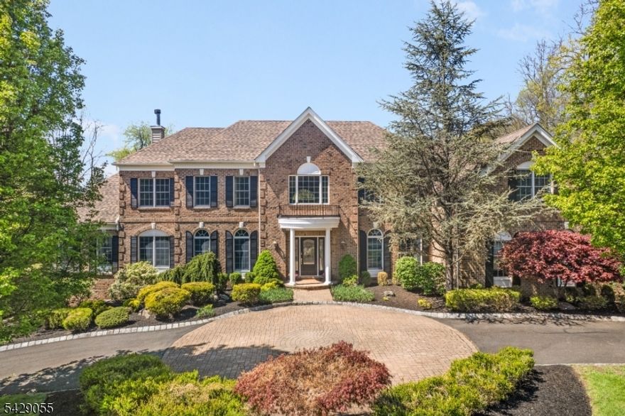 Utterly captivating brick front Custom Colonial personifies elegance & sophistication & set back beautifully from the road on a cul-de-sac in sought after neighborhood.  11 rooms including 5 bedrooms, 3 full baths, powder room, 2 fireplaces, and volume ceilings. This 4,700 sq ft luxury home offers a gorgeous designer kitchen w premium  stainless steel appliances, center island and spacious dining area; fantastic family room with pass thru fireplace; elegant living room, tasteful dining room with tray ceiling, sunken solarium, comfortable home office; superb primary bedroom suite with private sitting room with gas fireplace, voluminous walk-in closet, & luxurious bath--this home also offers a sprawling unfinished lower level with walk-out and 9' ceilings offering future opportunities for media, recreation & exercise areas; 3- car attached garage with circular driveway with Belgian block curbing and ample parking. Stunning outdoor hardscaping including a stone archway entrance to rear yard, outdoor kitchen, stone fireplace, 2 stone patios-perfect for informal dining, plus a jaw-dropping free-form, heated in-ground swimming pool with spa, natural waterfall feature replete with sliding board, and a spacious pool house, lavish 2-acre showcase property further enhanced by night accent lighting, 19-zone underground sprinkler system, and rustic woodland borders providing complete privacy.  Move-in ready beauty with brand new roof &  no-maintenance brick & vinyl exterior.