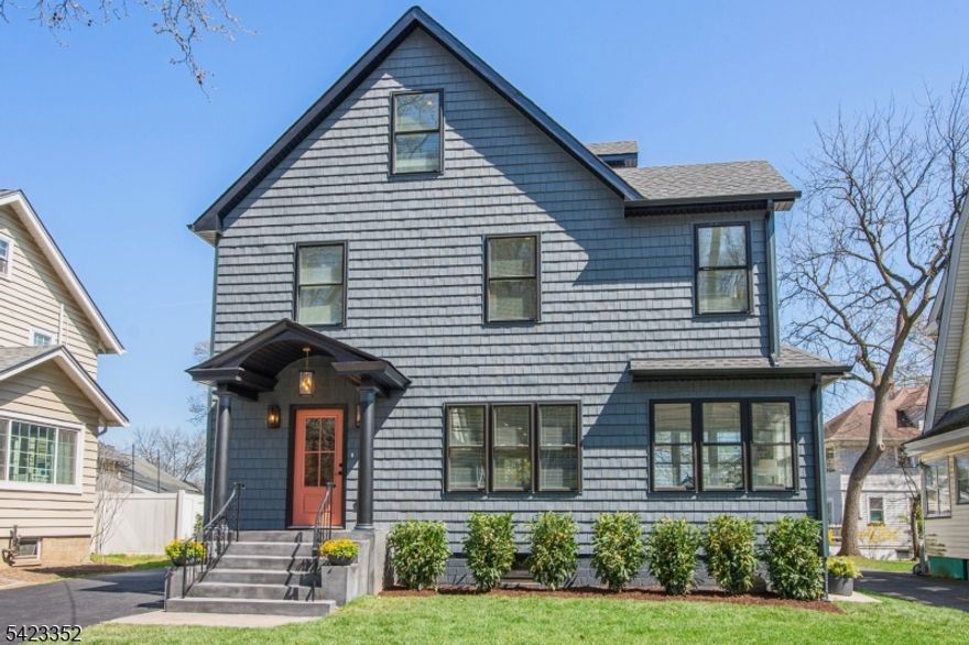 This newly Renovated Contemporary Colonial is set along one of Bloomfield's beautiful tree lined streets, where classic refinement meets modern luxury. A dramatic front entrance with a striking glass door, curated lighting, and expansive windows creates a warm welcome at dusk. The home offers four bedrooms, four full baths, and a first floor powder room. The spacious living room with a two sided fireplace opens to an additional sitting room, while oak hardwood flooring flows throughout. The bespoke kitchen and wet bar feature custom cabinetry, Calacatta quartz countertops, Klien appliances, and a walk in pantry. The primary suite is a sanctuary with a spa inspired bath, a walk in shower for two, rich finishes, a custom closet, and oversized windows framing mesmerizing views. Additional bedrooms are generously sized, filled with natural light, and include custom closets. A serene third floor suite provides an extra bedroom, den, and full bath with treetop vistas. The inviting family room offers custom built ins, a full bath, and a dedicated laundry room. From the kitchen, step onto your private deck and custom patio overlooking an expansive yard with newly planted landscaping and full property irrigation. The home includes efficient two zone heating and cooling for year round comfort. A modern tankless water heater provides endless hot water and energy efficiency. Privacy fencing completes the outdoor space, all moments from NYC transit, great amenities, and beautiful parks.