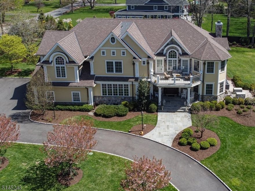 GRAND IN STYLE & DESIGN!   One-of-a-kind custom home perfectly blends elegance with today's lifestyle and is in a fabulous neighborhood! Enjoy spacious rooms, abundant windows, recessed lighting & gorgeous wood grain porcelain floors throughout. This homes greets you with the GRAND foyer & an ELEGANT winding staircase & DOMED ceiling.  The living room with glass pocket doors leads to the generous family room with wood burning fireplace and special stone feature wall.  The GOURMET KITCHEN features Thermador Premium SS appliances, a 48' stove with 6 burners, griddle & steam oven! It even has a pot filler! A MASSIVE island and dining area are a delight to any chef and are perfect for entertaining. A walk in pantry has plenty of  room for all your extras. The BUTLERS PANTRY is another special feature with wine refrigerator, ice maker, dishwasher & sink. This flows seamlessly into the EXPANSIVE dining room with coffered ceiling & custom moldings. The first floor also offers an office/bedroom with an adjacent full bath and mud room. Upstairs, double doors open to the private Primary suite with vaulted ceilings, sitting room, walk in closet, full bath with oversized shower, clawfoot tub & water closet! The second floor's extra wide hallway leads to three more bedrooms, a media room, laundry, two full baths with double sinks & the BALCONY! The oversized bluestone patio features a gas firepit & overlooks the professionally landscaped private backyard perfect outdoor parties. STUNNING!