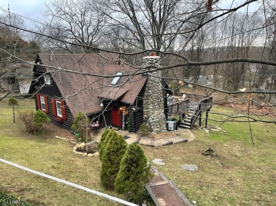 This charming original Crane-style cottage offers the perfect blend of comfort and character. Located in the sought-after Lake Mohawk community, this inviting home is ideal as a weekend retreat, year-round residence, or investment opportunity. Set on a peaceful property, this home welcomes you with a warm and rustic feel, featuring approximately 900 square feet of thoughtfully designed living space. Features include a gorgeous stone fireplace, vaulted ceilings, wood floors, and skylights. The easily accessible loft is used as a 2nd bedroom. Outside, the huge deck allows you enjoy the tranquility of nature with space to unwind, entertain, or simply take in the serene surroundings. Located just minutes from the lake, you'll have easy access to beaches, boating, dining, and year-round recreational activities. Whether you're looking to escape the hustle and bustle or invest in a desirable lake-area property, this cozy Sparta cabin is a rare find that delivers charm, convenience, and lifestyle all in one.