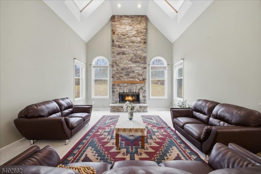 Experience refined living in this elegant east facing Toll Brothers 4-bedroom Colonial, showcasing a stately brick front, inviting curb appeal, and a beautiful mountaintop view framed perfectly from the front door. A grand two-story foyer with a brass chandelier sets a sophisticated tone, complemented by 9 ft. ceilings and hardwood flooring on the main level. A private office with French doors offers an ideal workspace, while the formal Dining Room provides a graceful setting for gatherings. The spacious Great Room features custom built-ins and surround-sound wiring, and the impressive Family Room offers a cathedral ceiling and a floor-to-ceiling stone fireplace that anchors the space. The oversized eat-in Kitchen includes premium appliances, a generous center island, and a convenient back stairwell leading to the second floor. Upstairs, the expansive Primary Bedroom Suite presents a serene sitting room, multiple walk-in closets, and a flexible area ideal for a second sitting room or nursery. The luxurious ensuite bath includes double vanities and a jetted soaking tub for true relaxation. With a thoughtful layout, abundant natural light, and versatile living areas, this beautifully designed home blends comfort, elegance, and timeless appeal.