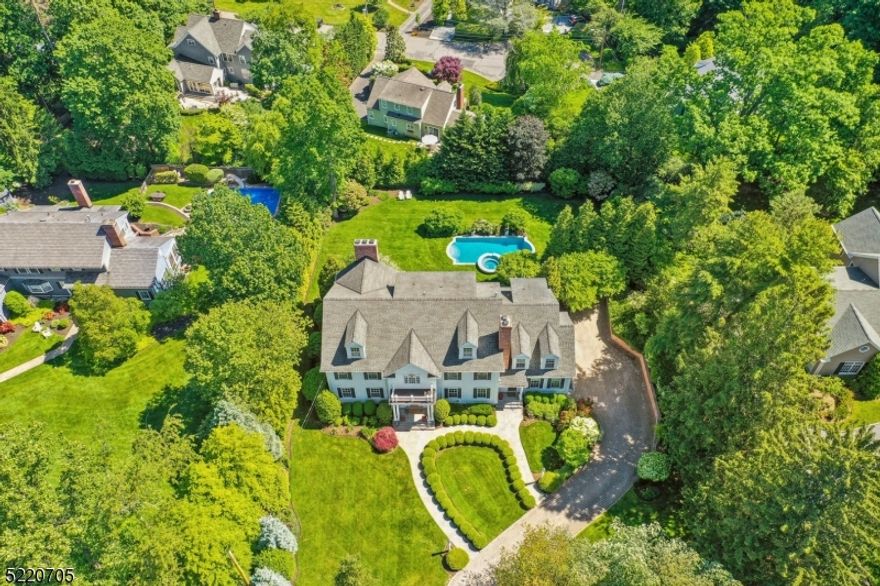 Experience the upscale lifestyle and resort style living in this classic white Colonial that offers everything that home buyers want today and more including an open floor plan, architectural interest, spectacular brand new chef's kitchen, lower walk out level and third floor living spaces and a private .72 acre property with salt water pool perfectly located in the sought after Hill section of Madison just blocks from town & train!  Quality built by WP Lloyd, this residence is impressive with high ceilings, gleaming hardwood floors, custom millwork, 7 generous bedrooms all ensuite, a first floor bedroom and office and a 3 car garage. The brand new white kitchen boasts a Wolf stove, sub zero fridge, marble counters, custom cabinetry, large breakfast bar, and opens to a custom bar with sub zero wine fridge, a breakfast room and a family room with gas fireplace. A banquet sized formal dining room, living room, & powder room complete this 1st level. The 2nd level boast 5 bedrooms all en-suite, a laundry room and a primary suite with a newer full bath and walk-in closet.  Continue to the third level with a bonus room, bedroom and full bath and the lower level features a large recreation room, full bath, exercise room and plenty of storage. Enjoy entertaining inside and outside in this spectacular home and you are sure to feel like you are on vacation lounging by your pool in your private yard full of lush plantings mature trees and shrubbery. This is a home you must see!