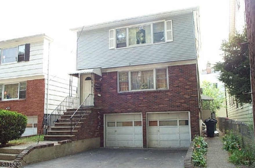 Two family home offering spacious layouts, and excellent rental potential in a convenient Newark location. Each unit features three well-sized bedrooms, an eat-in kitchen with a seperate dining area off the large living room and a full bathroom.. The two car attached garage  can be convenienly accessed from both apartments. The basement is partially finished with a full bathroom and a seperate entrance making it ideal for  additional use. With its low-maintenance exterior and practical layout, this property is ideal for both homeowners and investors seeking a solid multi-family opportunity.  House need work and is being sold as is.