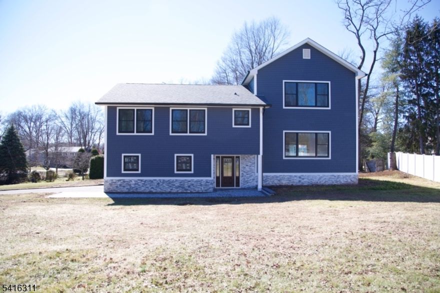 Totally renovated in 2025! Luxury abounds in this magnificent, one-of-a-kind, custom style home offering 4 bedrooms and 3.5 bathrooms. The home offers hardwood floors,10 ft. ceilings throughout most of home, and a thoughtfully designed open-concept layout-perfect for today's lifestyle. The stunning kitchen is the heart of the home, complete with quartz countertops, abundant cabinetry, high-end appliances, and a breakfast bar -effortlessly flowing into the dining and living areas-ideal for everyday living and entertaining. A spacious deck is situated outside the dining area-perfect for hosting guests or enjoying a quiet morning coffee or evening cocktail. All bedrooms are generously sized. The private primary suite, set apart for added privacy, offers a true retreat with a spa-inspired bathroom featuring a tub/shower plus a large walk-in shower. In addition to the primary suite, there is also a guest suite with full bathroom.  The family room opens to a paver patio overlooking a serene, park-like yard. A finished basement provides additional living space, while a 2 car garage adds everyday convenience. Nestled in one of East Hanover's premier neighborhoods, along with top-rated schools, this home delivers an exceptional sense of peace and friendly community living. Ideally located near major highways, NYC trans, shopping and dining-convenience is at your doorstep. Brand new construction with top of the line finishes and a sleek modern design, this home truly has it all.