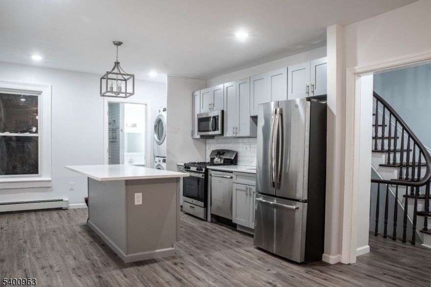 Welcome to 1076 Fulton St- a beautifully renovated 4-bedroom, 2-bath duplex in a prime Rahway location. Step into a modern, thoughtfully designed home featuring an open eat-in kitchen with brand-new custom cabinetry, stainless steel appliances, and sleek quartz countertops. The entire apartment is finished with luxury vinyl plank flooring, adding both style and durability. The second floor offers a spacious living room, modern full bathroom, and a versatile fourth bedroom that can also serve as a home office or playroom. The third floor includes three well-sized bedrooms, each with its own closet, plus an additional full modern bathroom. A dedicated laundry closet adds everyday convenience. Enjoy 1 off-street parking space and access to an enclosed backyard, perfect for outdoor relaxation. Tenants are responsible for heat, hot water, cooking gas, and electric. Unbeatable location close to the Rahway Train Station, shopping, restaurants, parks, and major highways ideal for commuters and anyone seeking convenience.