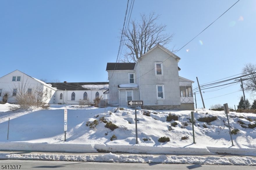 Opportunity awaits in this classic 2-story home situated on an elevated lot in downtown Hamburg. Featuring 3 bedrooms, 1 full bath, and a traditional layout with separate living and dining areas, this property offers strong potential for renovation and customization. The home includes an eat-in kitchen, hardwood flooring in select rooms, enclosed front porch, and ample natural light throughout. Public utilities. Convenient location near shopping, schools, and commuter routes. Property is being sold strictly as-is. Great for buyers looking to restore and add value. With vision and updates, this home can be transformed into a charming primary residence or investment property.