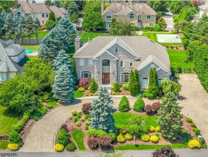 5,000+ Sq Ft Residence Curved Staircase Private Lower-Level Living Designed for layered living and effortless flow, this expansive residence offers a refined balance of scale, structure, and flexibility. A dramatic double-height foyer introduces a signature curved staircase, creating a striking architectural focal point and a strong sense of arrival.The main level unfolds into generously proportioned living spaces, including formal living and dining rooms, an inviting fmy-room, and an open-concept kitchen with breakfast area. Large windows and French doors bring in abundant natural light while seamlessly connecting interior spaces to the outdoor terrace and landscaped grounds. The second level is thoughtfully arranged with a spacious primary suite and multiple well-sized bedrooms positioned across two distinct wings, offering both privacy and functionality. A secondary staircase enhances everyday circulation and convenience. The fully finished lower level is designed as a private living suite, complete with its own entrance to the backyard, kitchen, bedroom, bathroom, laundry, and direct patio access ideal for living, guests, or flexible use. Additional highlights include a stone exterior façade, circular driveway, 3-car garage, and finished attic providing additional usable space.A rare offering that combines architectural presence, open flow, and multi-level living versatility in one exceptional home.