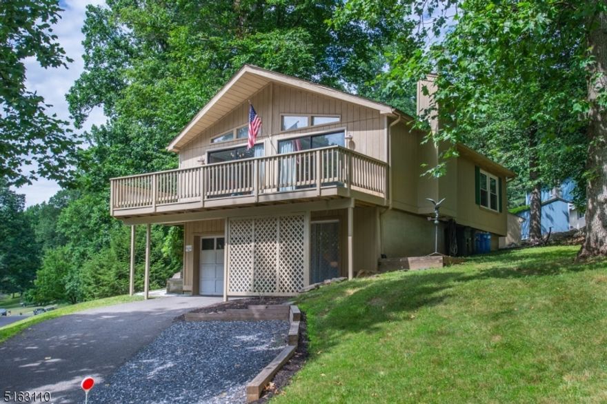 Fantastic open floor plan with lots of natural light on double sized lot and seasonal views of Spruce Run Reservoir! Wraparound deck, vaulted ceilings, garage, finished walk-out basement, updated kitchen, community with playground and pool. ***Air conditioning lease to be paid in full at closing by Seller.***  So much house and amenities for the $$!!  Do nothing but move in, also perfect 2nd home.