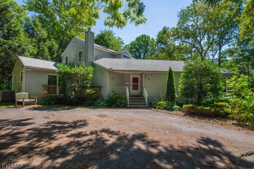 Expansive contemporary home on a park-like 1-acre property. Tons of privacy from the long driveway and surrounding woods, yet part of a warm and friendly community. House is spacious, open, and bright with many oversized windows and skylights, offering natural light and great views. Versatile layout, hardwood flooring, large rooms, and a wrap-around deck make this house perfect for entertaining, both indoors and outside. The 1st floor has 2 bedrooms and 2 full baths, including a handicap shower as well as an eat-in kitchen, living room, dining room, and den with a wood-burning fireplace. 2nd floor has a master bedroom suite with full bath, 2 walk-in closets,  a sitting area, and an office with a window and a closet.Unique layout to suit many buyers who are looking for a great entertaining space or a place to relax in an upstairs "retreat" away from the hustle and bustle going on downstairs.. Many important upgrades - brand new ac compressor, hot water heater, washer and dryer. Furnace less than 10 years old. 3 Zone natural gas heating. Appliances are electric but can be converted to gas. All Public utilities. Minutes from downtown, shopping, restaurants, highways & commuter locations. Rare value in the center of a desirable lake community in prestigious Mtn Lakes which was ranked #2 for best places to live in NJ*. AWARD WINNING SCHOOLS!