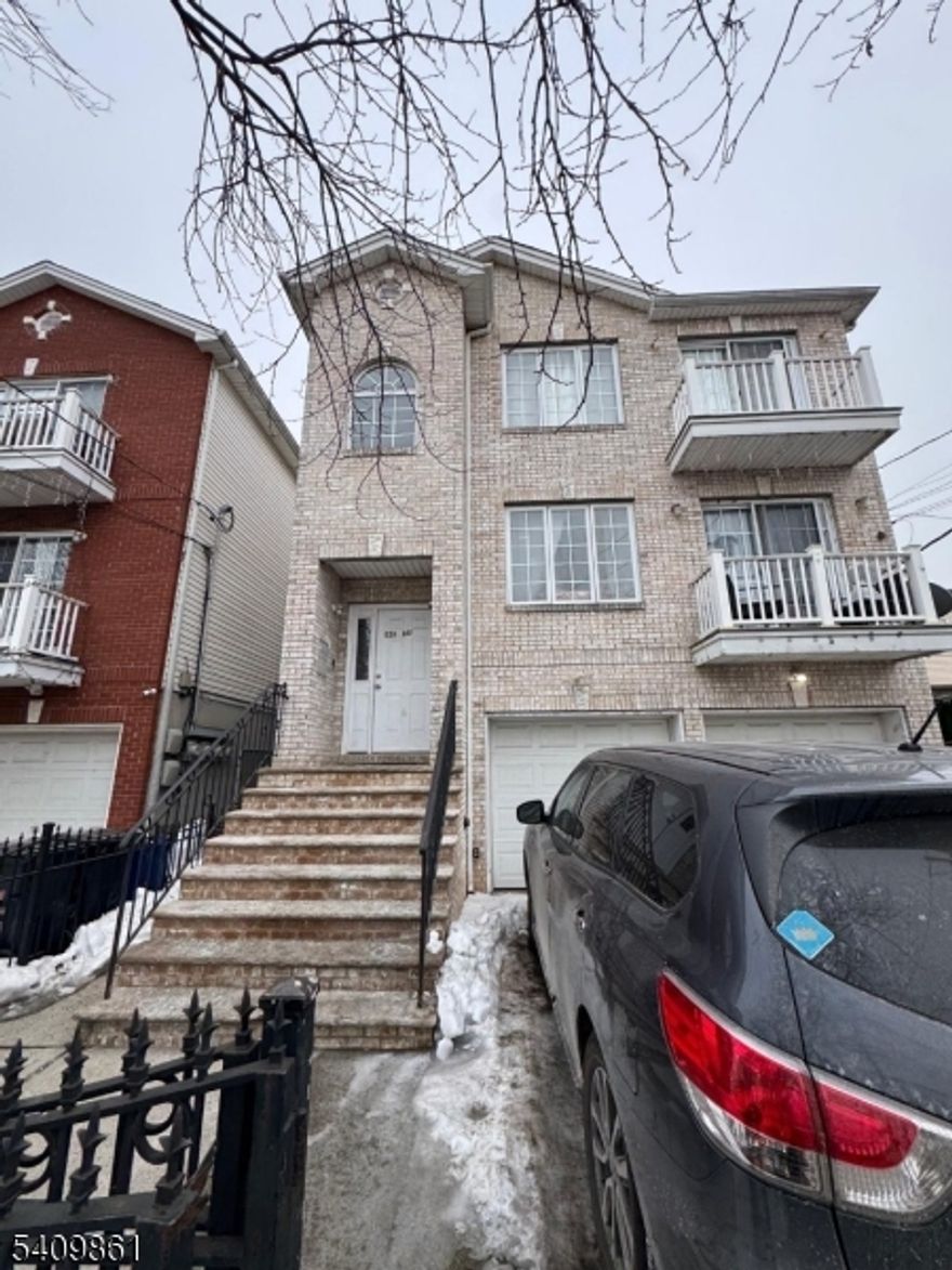 Newer "Three Family Home" Located near Branch Brook Park, GS Parkway & Newark Schools Stadium - Featuring Brick Front, Hardwood Floors, Central Air, 2 Car Garage, Low Taxes & much more