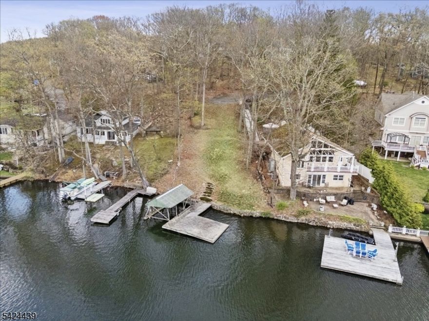 Rare Lakefront Opportunity in highly desirable No Wake Crescent Cove with Stunning Sunset Views!  Set along the shores of Lake Hopatcong, the largest lake in NJ, in this very serene and secluded cove, this exceptional parcel offers the perfect canvas to bring your vision to life.  Spanning over .50 acre, the property captures breathtaking western exposure, delivering unforgettable sunsets and a tranquil waterfront setting ideal for both year-round living and a luxurious weekend escape.  Swim, kayak, paddle board etc. without fear of being caught in the wake of a fast moving boat. This raw land presents the opportunity to install a 4-bedroom septic system, approved by the Sussex County Board of Health allowing flexibility to design a custom home tailored to your lifestyle. With ample space, and Hopatcong Land Use Board Approvals for a Single Family Home, 2-car detached garage and a boathouse, creating a seamless indoor-outdoor living experience with direct access to the lake. Imagine mornings on the water, afternoons boating, and evenings unwinding as the sun sets over the horizon. Enjoy all that Lake Hopatcong has to offer, from vibrant waterfront dining and recreation to a peaceful retreat just a short distance from major highways and commuter routes. Whether you envision a private getaway or a full-time residence, this is a rare opportunity to secure prime lakefront land and build exactly what you've been dreaming of. Survey and approved building plans are available upon request.