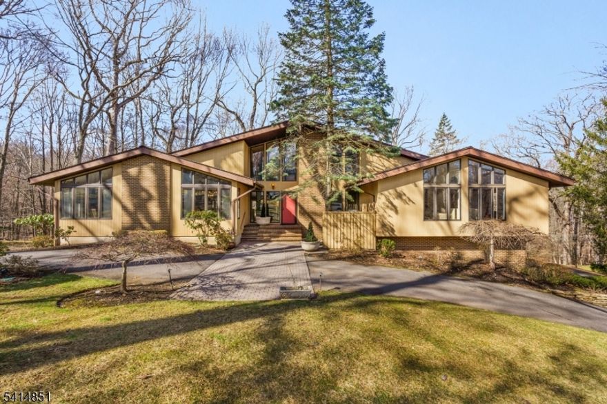 Situated in a picturesque neighborhood of Warren Township, this custom contemporary home showcases one level living at its best boasting an open floor plan designed for grand entertaining & effortless everyday living.An inviting foyer immediately draws you into the dramatic family room, where soaring ceilings & expansive walls of glass bathe the interior in natural light & seamlessly invite the surrounding landscape indoors. A floor-to-ceiling fireplace serves as an architectural focal point, defining the family room from the adjoining living room while preserving the home's open,airy flow. Both spaces feature sliding glass doors that lead to the deck,creating a harmonious indoor-outdoor lifestyle experience.The formal dining room is equally impressive, highlighted by a large picture window w/transom accents that frame tranquil views of the front grounds.The eat in kitchen is a sizable room featuring a center island, vaulted ceilings & offers great space for entertaining & cooking. All 3 bedrooms are located on the main level including a primary suite w/floor to ceiling windows, 2 walk-in closets & a spacious bath w/ soaking tub & stall shower. A versatile loft overlooks the living area & is currently utilized as a home office. The daylight basement is equally impressive, w/exceptionally high ceilings, a beautiful full bath,partially framed & ready for finishing, this lower level presents the opportunity to customize additional living. space.